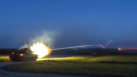 Challenger 2 tank firing at night, captured in a dynamic military HD desktop wallpaper and background.