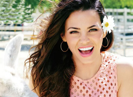 HD desktop wallpaper of American actress Jenna Dewan with brunette hair, green eyes, and a bright smile, wearing hoop earrings and a flower in her hair.