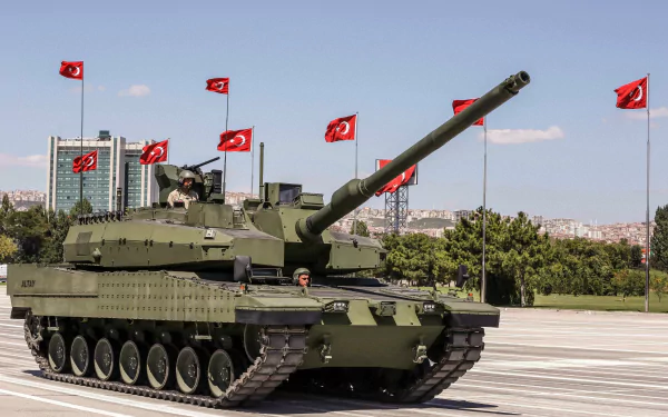 HD desktop wallpaper showcasing an Altay military tank on a paved open area with multiple Turkish flags in the background under a clear sky.
