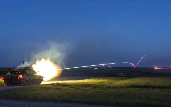 Challenger 2 tank firing at night, captured in a dynamic military HD desktop wallpaper and background.