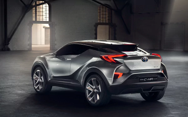 Silver Toyota C-HR concept SUV showcased in a spacious industrial setting, captured in 4K Ultra HD for a striking PC desktop wallpaper.