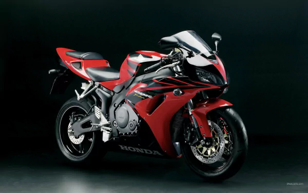 HD PC desktop wallpaper/background: red Honda CBR600RR sport motorcycle on a dark backdrop, showcasing sleek fairings and exposed aluminum frame.