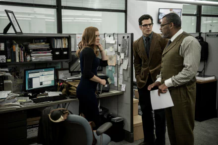Lois Lane (Amy Adams) converses with Clark Kent (Henry Cavill) and Perry White (Laurence Fishburne) in a bustling newsroom from Batman V Superman: Dawn Of Justice.
