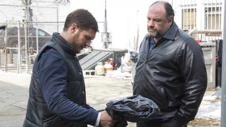 Two men in a gritty alley exchanging a wrapped package; still from the movie The Drop shown as an HD PC desktop wallpaper.