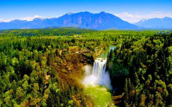 A vibrant HD landscape of Snoqualmie Falls surrounded by lush forest and mountains in Washington, captured as a stunning nature wallpaper background.