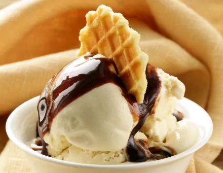 A close-up of a creamy ice cream dessert topped with chocolate sauce and a crispy wafer, shown as an HD PC desktop wallpaper and background.
