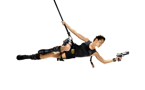 HD desktop wallpaper featuring Angelina Jolie as Lara Croft from the movie Tomb Raider, depicted in action pose with gun and harness against a white background.