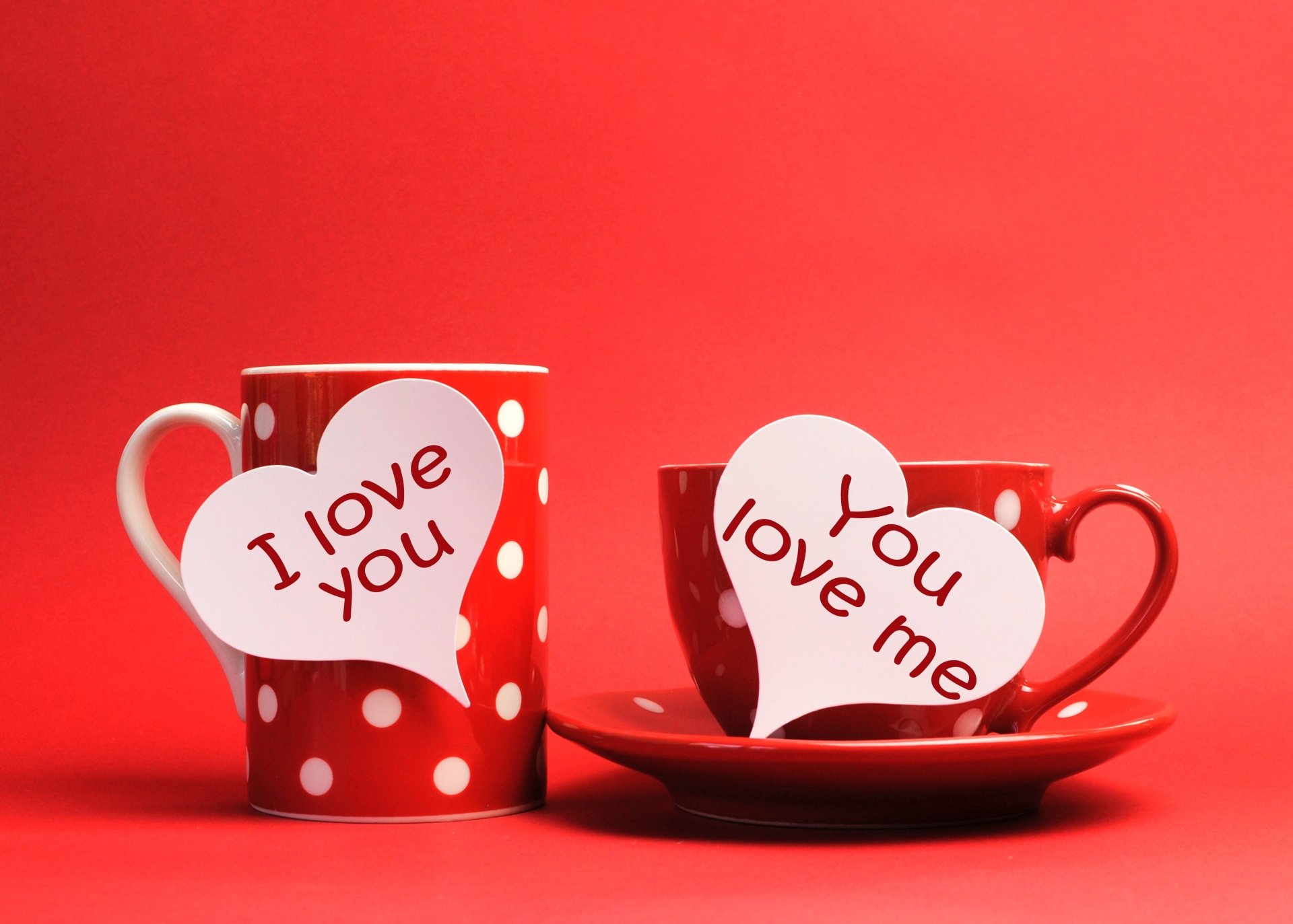 HD wallpaper featuring two red, polka-dotted cups with I love you and You love me hearts on a red background, symbolizing love.
