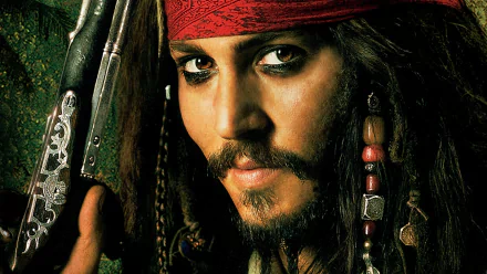 Jack Sparrow, portrayed by Johnny Depp in *Pirates of the Caribbean: Dead Man's Chest*, gazes intensely with his signature accessories, captured in this vibrant HD wallpaper.