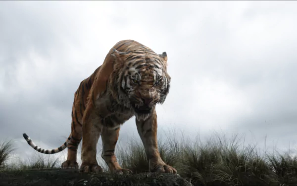 A striking HD wallpaper featuring Shere Khan from the movie The Jungle Book (2016), showcasing a powerful tiger poised against a dramatic sky.