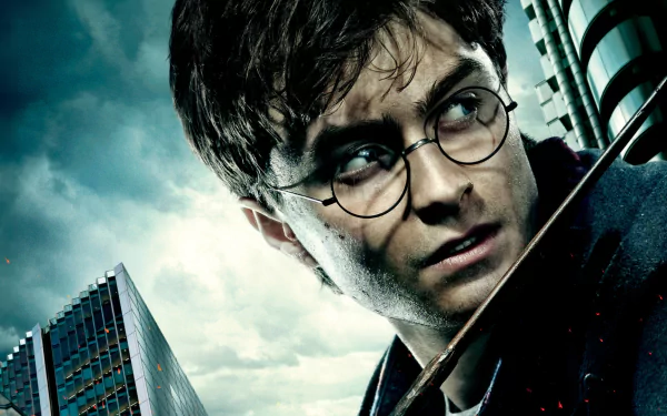 HD desktop wallpaper featuring Daniel Radcliffe as Harry Potter from the movie Harry Potter and the Deathly Hallows: Part 1, set against a dramatic urban backdrop.