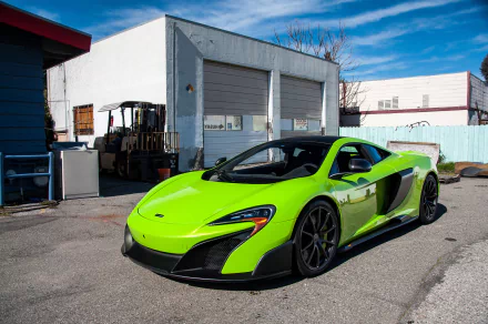 A vibrant green McLaren 675LT supercar parked outdoors, shown in high definition as a PC desktop wallpaper and background.