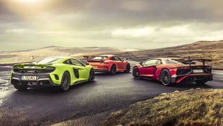 HD desktop wallpaper featuring a Porsche 911 GT3 RS, McLaren 675LT, and Lamborghini Aventador on a winding road, inspired by the Top Gear TV show.