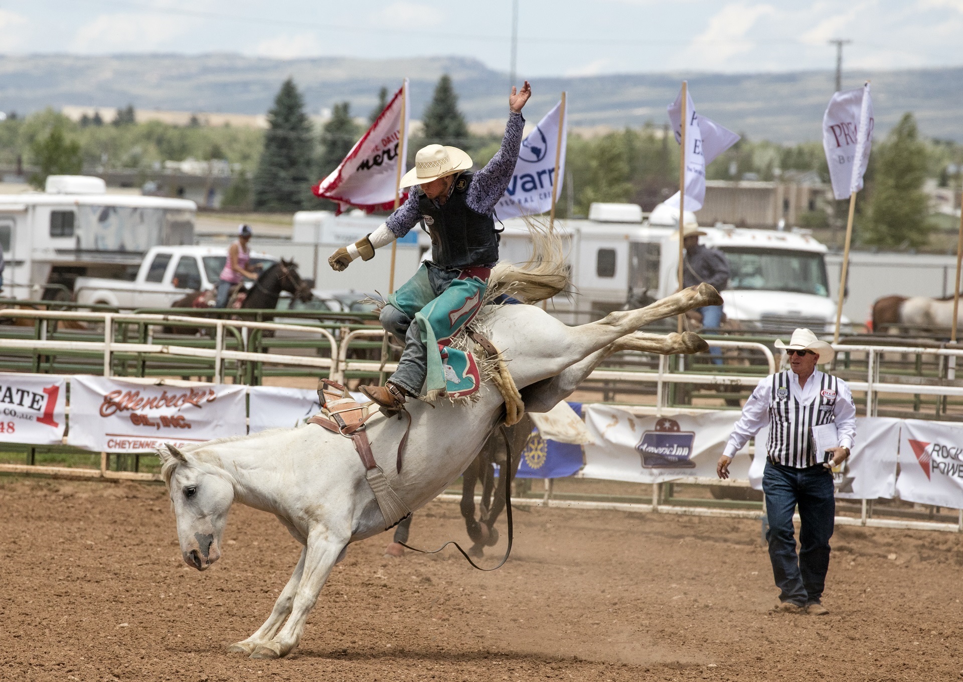 Thrown off a bucking bronco in a rodeo by skeeze
