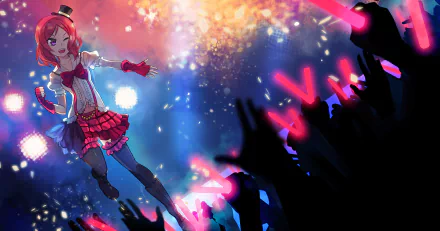 Maki Nishikino (Love Live!) in a red stage outfit singing above a cheering crowd waving pink glow sticks, vibrant lights and confetti — 2K Quad HD PC desktop wallpaper/background.