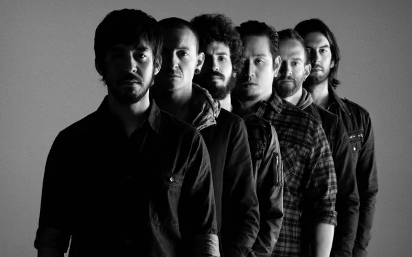 Black and white image of the rock band Linkin Park, featuring the band members standing in a row, showcasing their unique styles and expressions. High-definition desktop wallpaper.