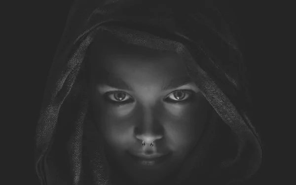 Black & white 4K Ultra HD wallpaper featuring a dark, gothic face with piercing eyes staring intensely from beneath a hood.