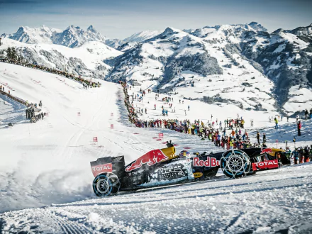 A Red Bull F1 race car navigates a snowy landscape, surrounded by mountains and a crowd, capturing the thrill of winter sports in stunning 4K Ultra HD detail.