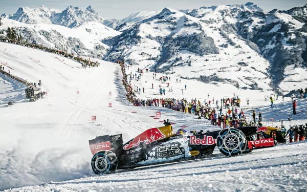 A Red Bull F1 race car navigates a snowy landscape, surrounded by mountains and a crowd, capturing the thrill of winter sports in stunning 4K Ultra HD detail.