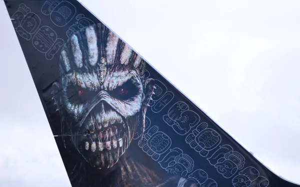 Airplane tail art showing Iron Maiden's Eddie snarling skull over repeating band logo — music-themed 4K Ultra HD PC desktop wallpaper and background.
