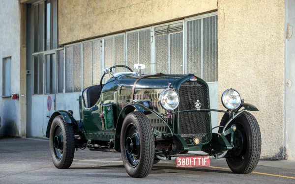 A classic green Delahaye vehicle parked in front of an industrial building in Brookland, captured in 4K Ultra HD for a PC desktop wallpaper.