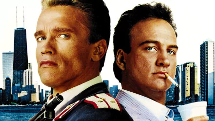 High-definition wallpaper featuring Arnold Schwarzenegger and James Belushi from the movie Red Heat, set against a city skyline backdrop.