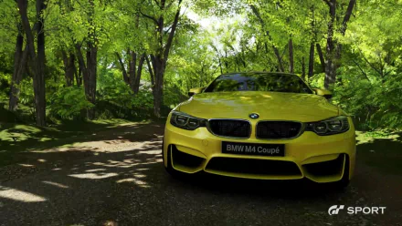 HD PC desktop wallpaper featuring a bright yellow BMW M4 Coupé in a forest setting, styled as a video game scene from Gran Turismo Sport.
