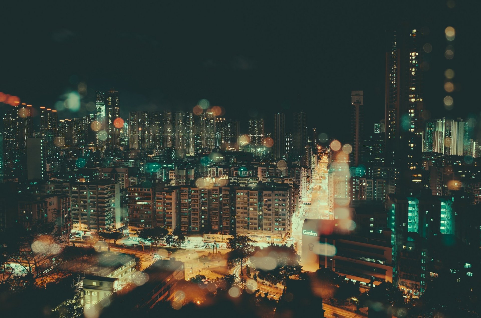 HD PC desktop wallpaper background: night urban cityscape with bokeh lights, glowing high-rises and man-made skyline blur.