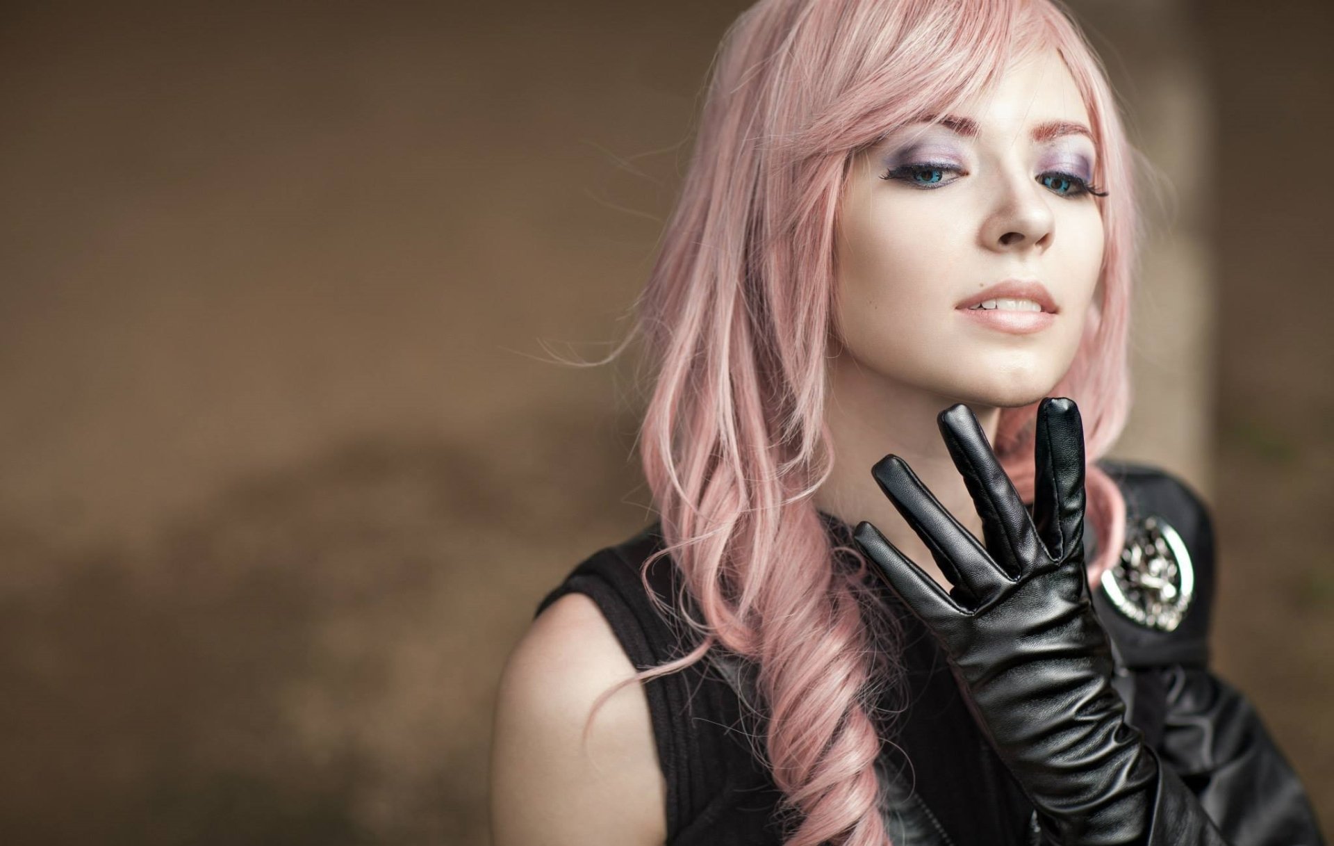 A woman cosplays as Lightning from Final Fantasy, featuring striking pink hair and a stylish black outfit, creating a captivating HD desktop wallpaper background.