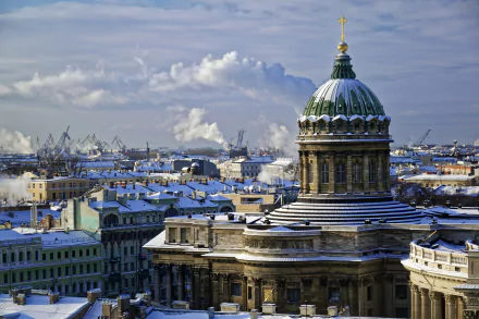 Snow-covered dome and historic buildings of Saint Petersburg, Russia, under a cloudy winter sky in this HD cityscape desktop wallpaper.