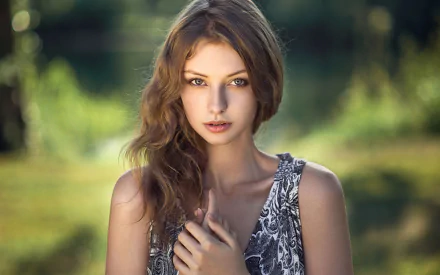 A captivating portrait of a woman with brown hair, set against a lush background. This high-definition image can enhance any desktop wallpaper or background.