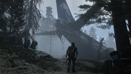 Deacon St. John stands amidst a misty forest, exploring the wreckage of a downed plane in this atmospheric HD wallpaper from the video game Days Gone.