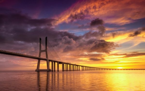 Man Made Vasco da Gama Bridge Bridges Sunset Bridge Ocean Sea Lisbon Portugal HD Wallpaper | Background Image