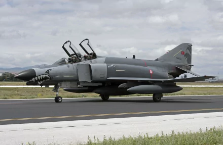 A McDonnell Douglas F-4 Phantom II jet fighter on the runway, showcasing its military design and power, captured in stunning 4K Ultra HD detail.