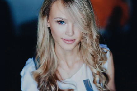 Close-up of a smiling blonde woman with blue eyes and softly curled hair, captured in HD quality as a desktop wallpaper and background.