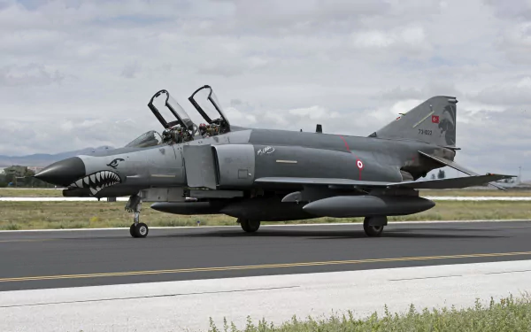 A McDonnell Douglas F-4 Phantom II jet fighter on the runway, showcasing its military design and power, captured in stunning 4K Ultra HD detail.