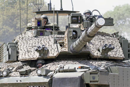 HD desktop wallpaper featuring a close-up view of a military Challenger 2 tank with soldiers visible inside, showcasing its detailed armored exterior and main cannon.