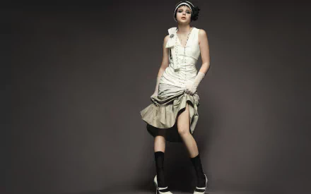 Chloë Grace Moretz poses elegantly in a stylish outfit with a veil and hat, showcasing modern fashion in this striking HD desktop wallpaper and background.