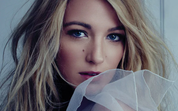 Close-up portrait of American actress and model Blake Lively with blonde hair and striking blue eyes, featured in an HD PC desktop wallpaper.