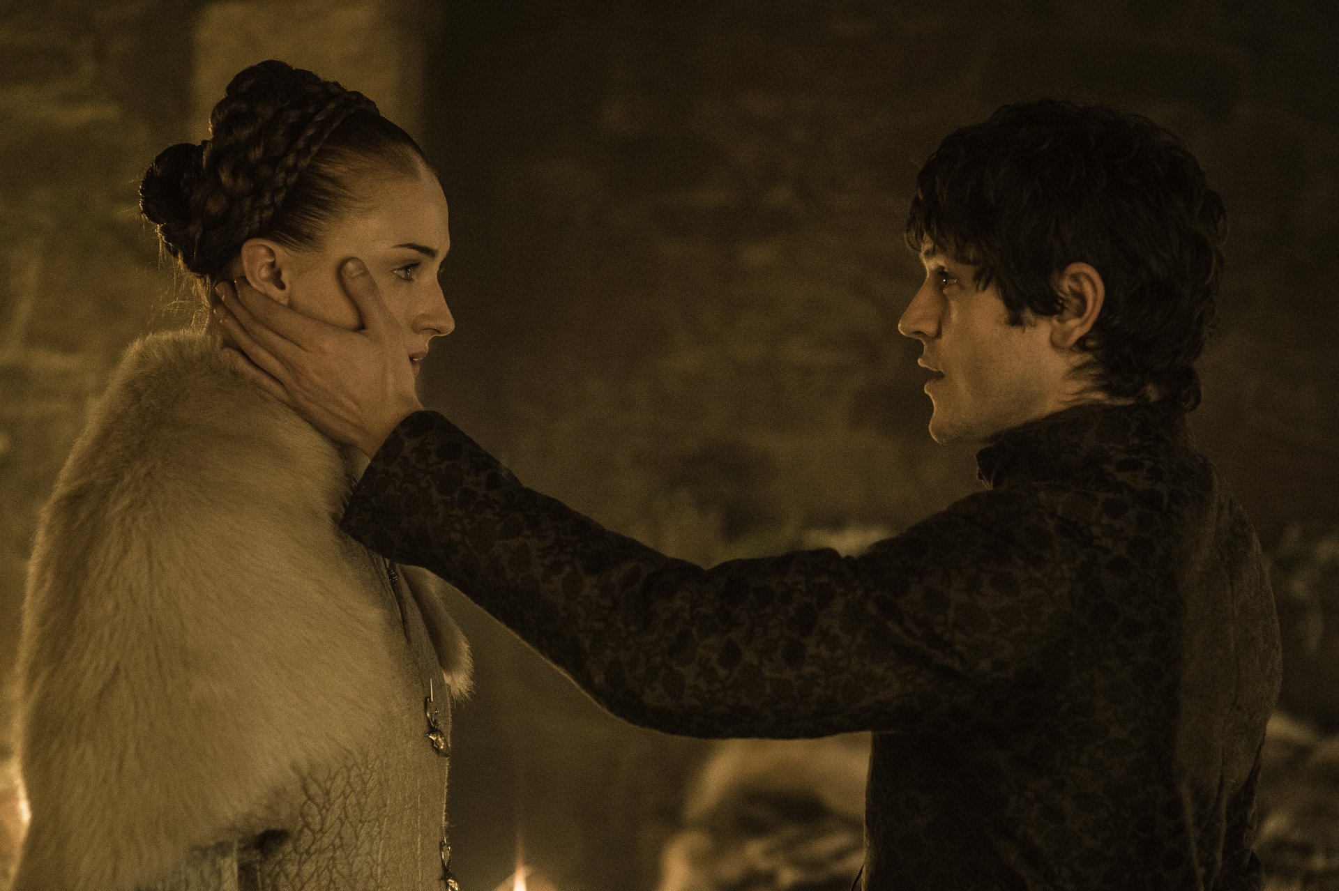 Sansa Stark, played by Sophie Turner, and Ramsay Bolton, played by Iwan Rheon, face each other in a tense scene from the TV show Game of Thrones.