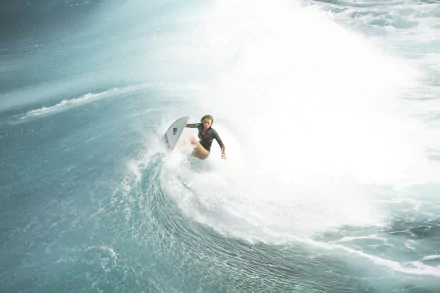 A surfer rides a massive wave in a dynamic scene inspired by the movie The Shallows, featuring Blake Lively as Nancy. An energetic desktop wallpaper capturing the thrill of surfing.