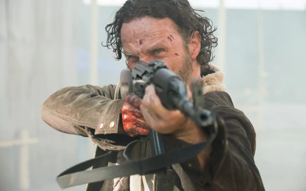 Rick Grimes, portrayed by Andrew Lincoln, aims a weapon in this intense scene from The Walking Dead, showcasing the gripping drama of the acclaimed TV show. HD PC desktop wallpaper.