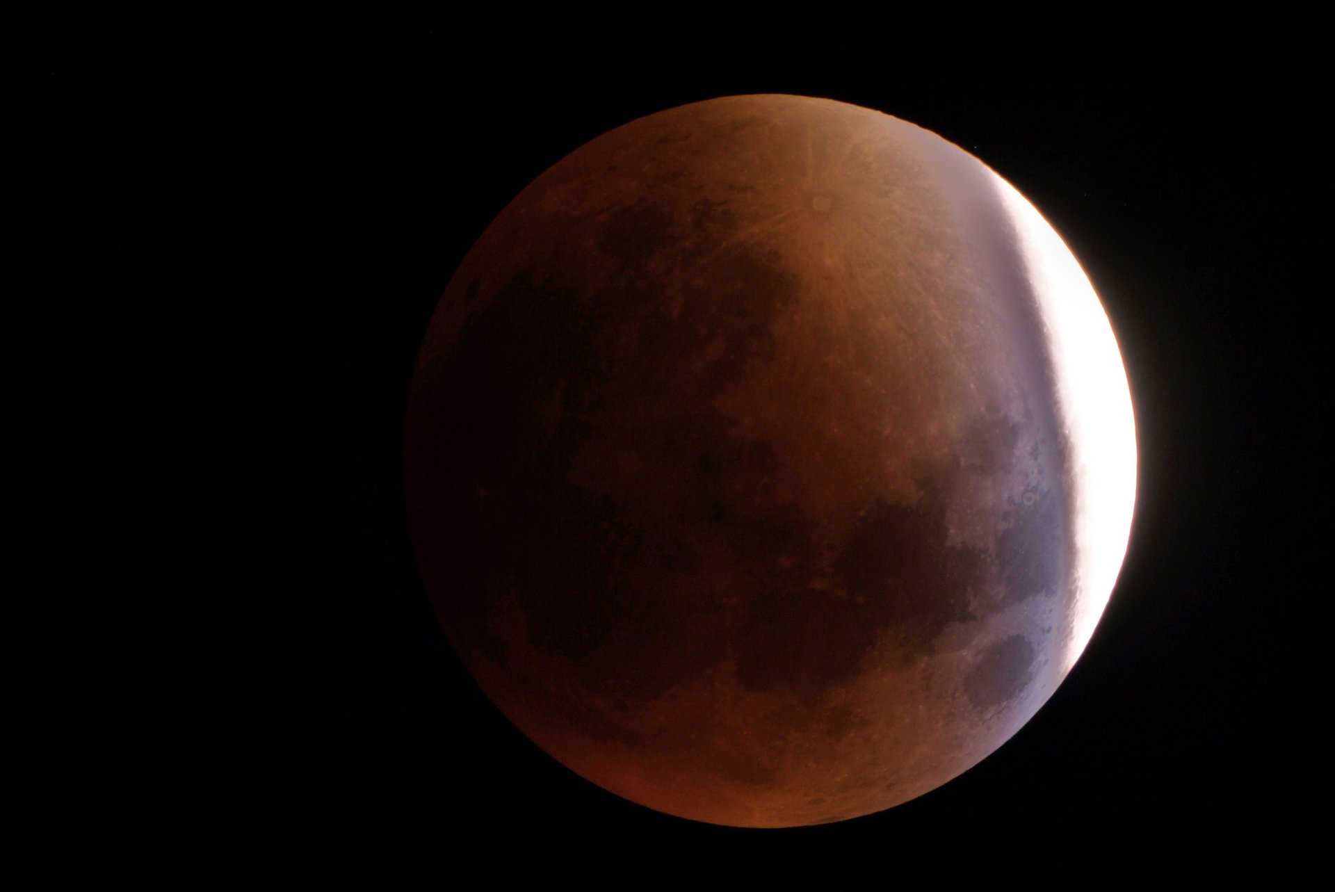 HD PC desktop wallpaper featuring a detailed view of the moon partially illuminated against a dark sky, highlighting natural lunar textures and shadows.
