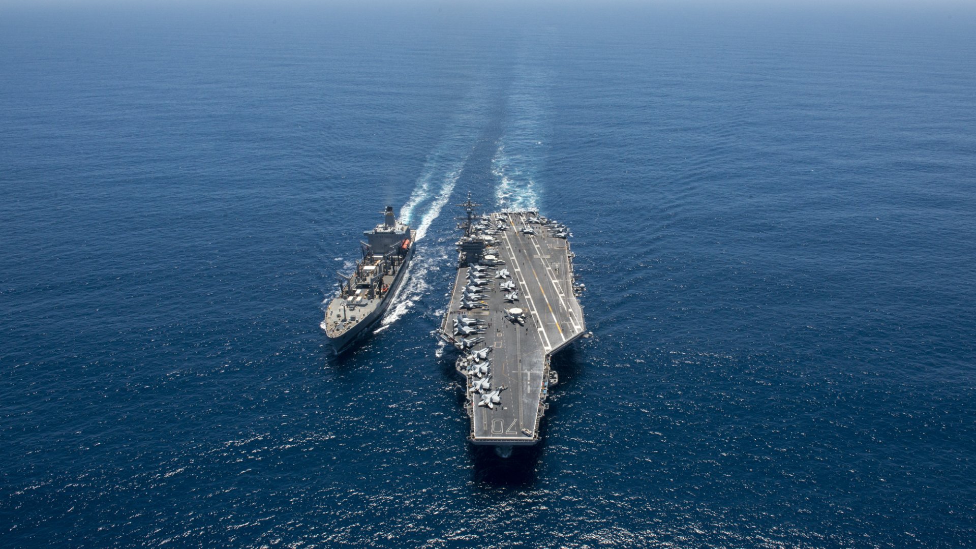 USNS Yukon (T-AO-202) replenishment oiler alongside the aircraft carrier USS Carl Vinson (CVN-70) sailing in open sea, military warships in HD desktop wallpaper.