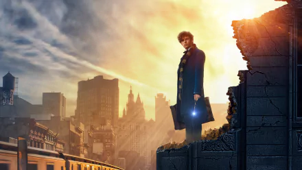 HD wallpaper featuring Eddie Redmayne from Fantastic Beasts and Where to Find Them, standing on a crumbling wall with a sunset-lit cityscape in the background.