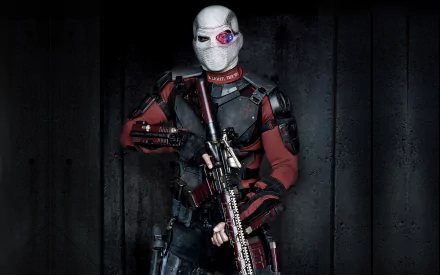 Deadshot, portrayed by Will Smith in DC Comics' Suicide Squad, stands menacingly with a gun, showcasing a striking HD wallpaper design with dark tones and intense character detail.