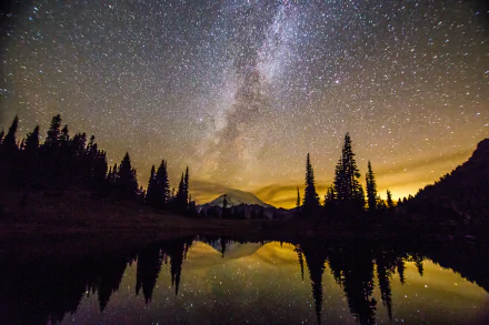 5K Ultra HD PC desktop wallpaper: Mount Rainier at night, silhouetted trees and peak reflected in a tranquil lake beneath a starry sky with the Milky Way over Washington.