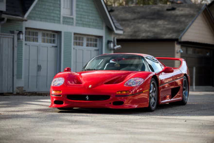 Red Ferrari F50 supercar parked in front of a garage, captured in sharp 4K Ultra HD for a striking PC desktop wallpaper and background.