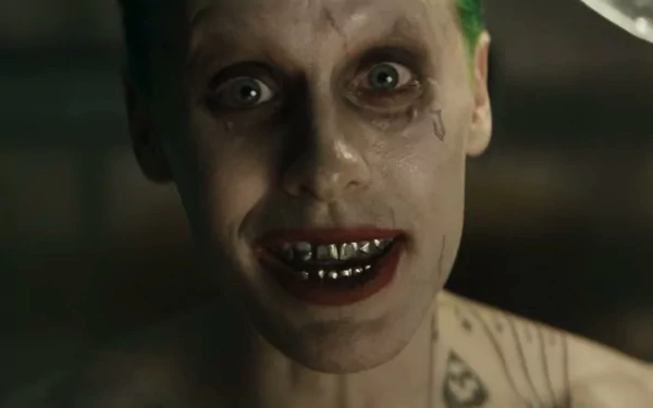 Jared Leto portrays the Joker in this intense scene from *Suicide Squad*, showcasing his distinctive look with green hair and striking tattoos. A compelling HD desktop wallpaper.