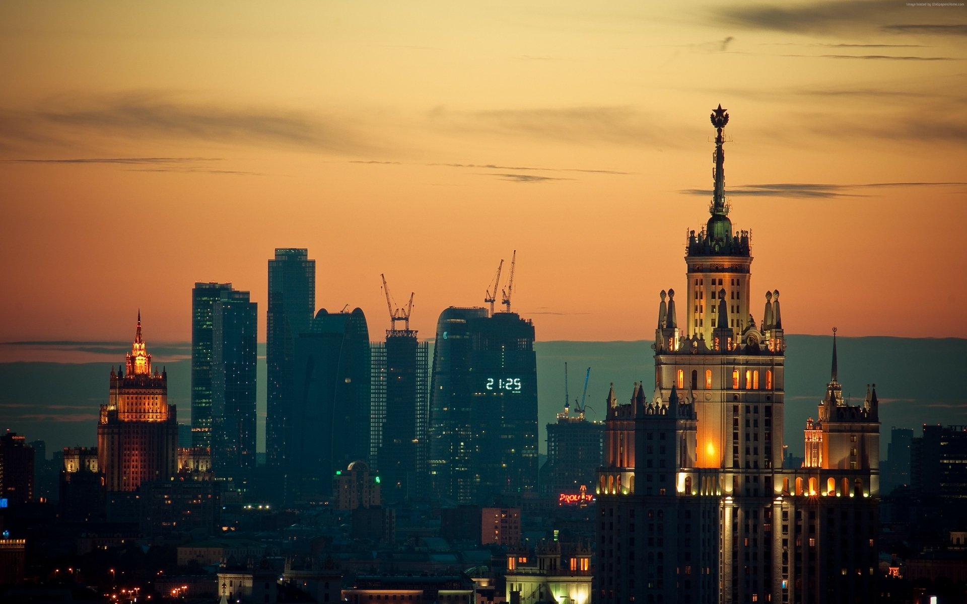 Sunset view of Moscow's skyline with illuminated historic and modern skyscrapers, captured in 4K Ultra HD for a stunning cityscape background.